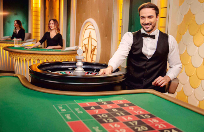 Roulette wheel featuring a man's hand dropping the ball into play